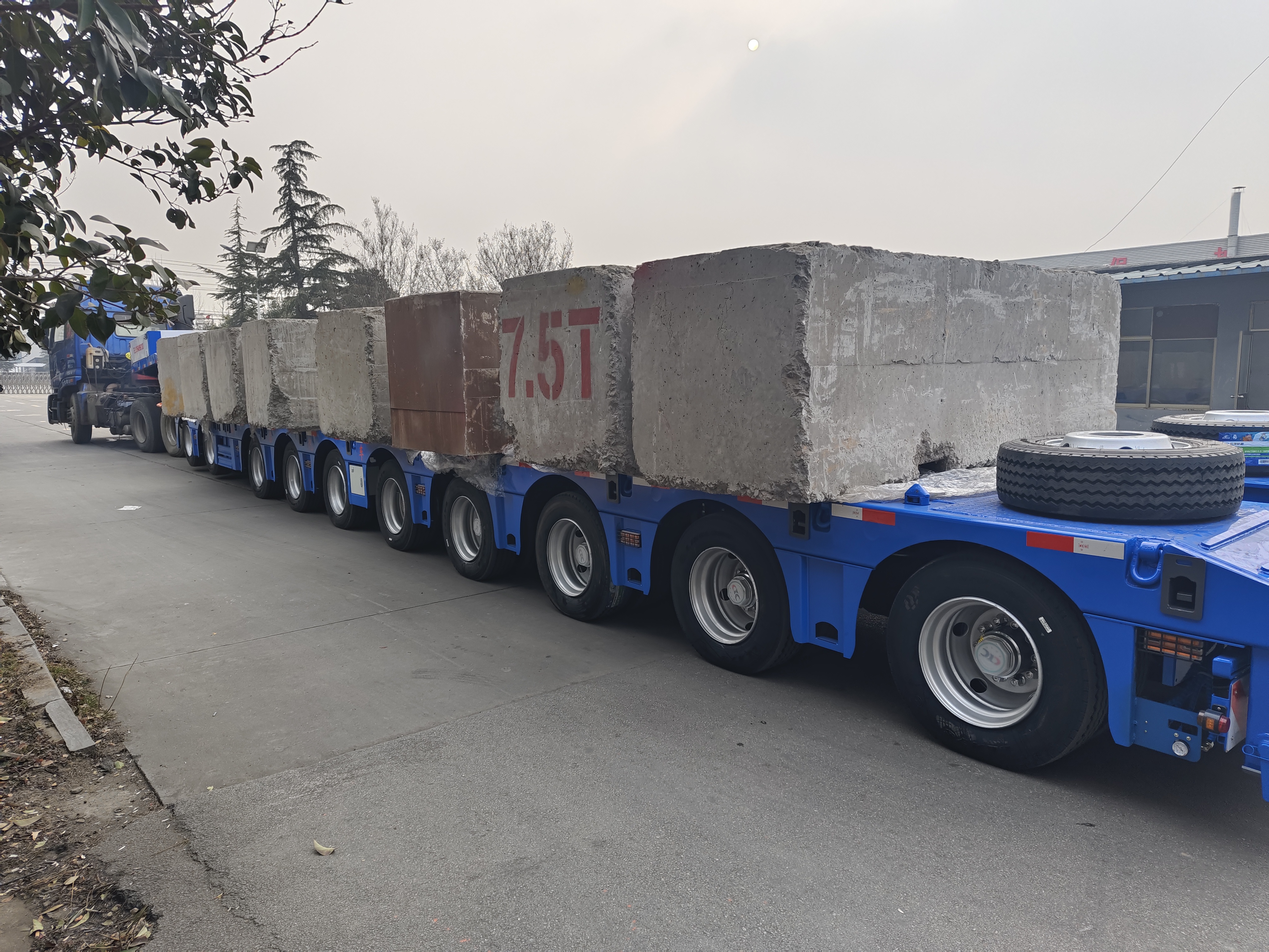 Heavy payload capacity demonstration of the 10 axle extendable lowbed trailer loaded with massive concrete blocks