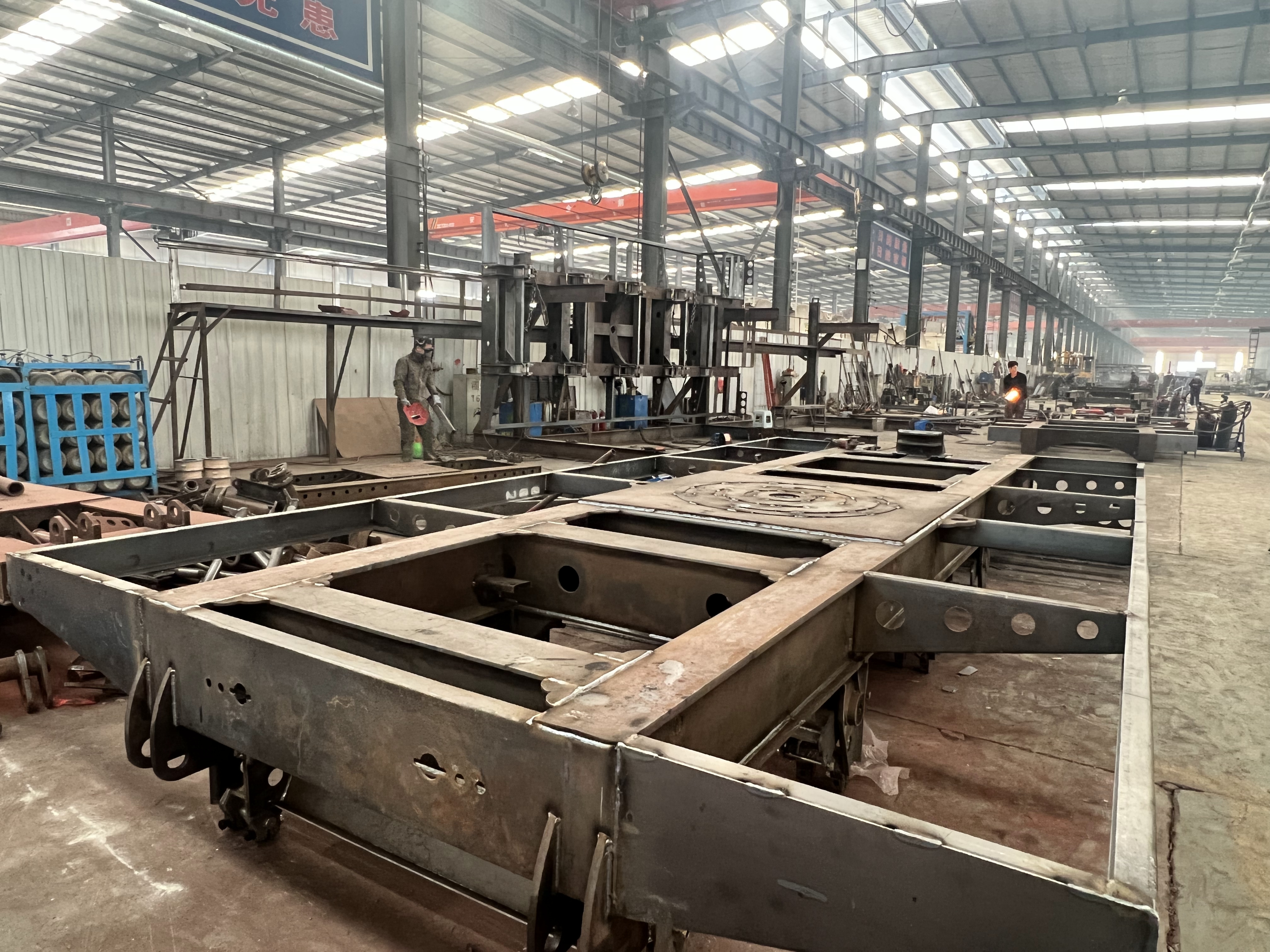 HUAYUE engineers and welders fabricating a custom high-strength steel chassis for a mobile substation trailer