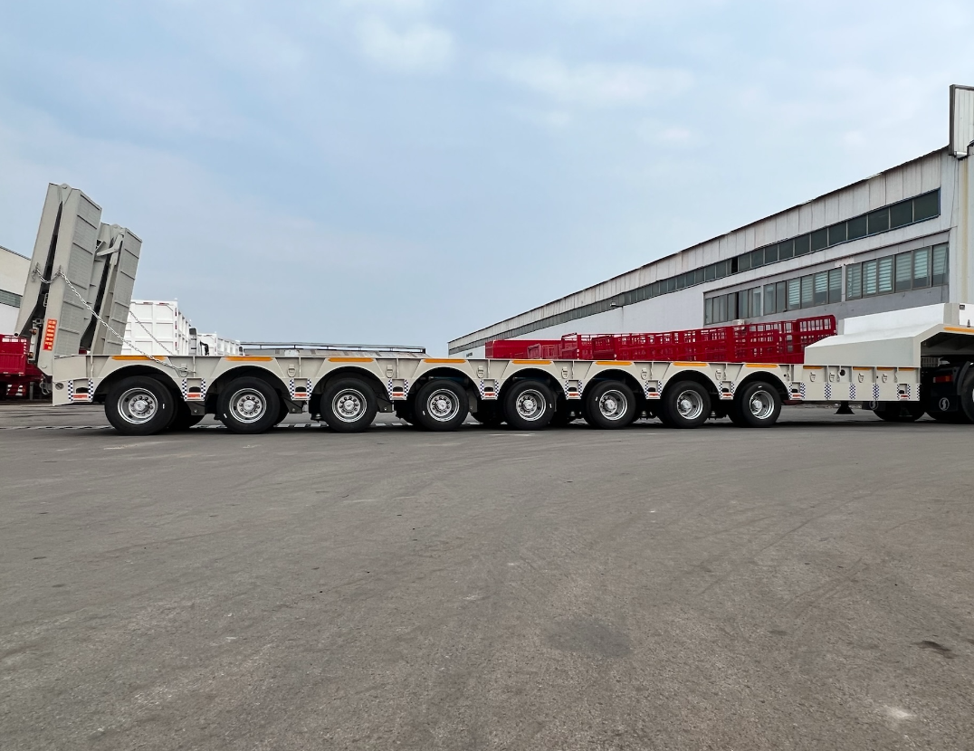 Full side profile of the HUAYUE 8-axle specialized lowbed trailer, showcasing its compact multi-axle matrix and ultra-low chassis center of gravity in the 17-meter closed position.