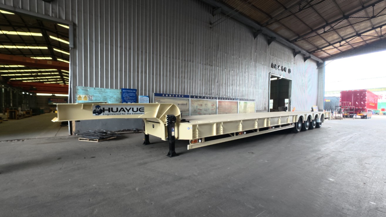 Side profile of a HUAYUE special heavy-duty trailer showcasing its high-strength metal checkered plate deck and robust gooseneck designed for extreme payloads.