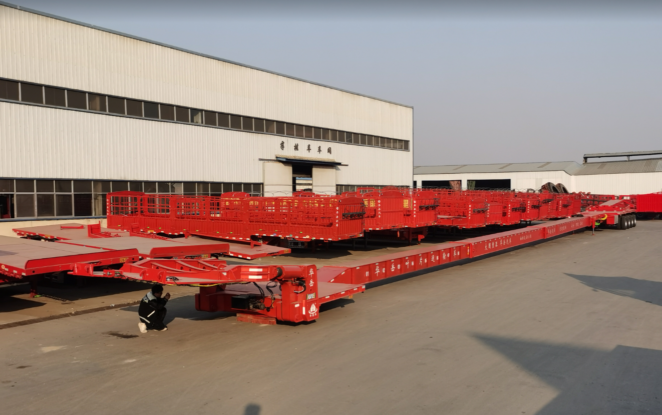 A semi-trailer loaded with an ultra-long wind turbine blade navigating a complex mountain hairpin turn, demonstrating the extreme length and steering challenges in heavy hauling.